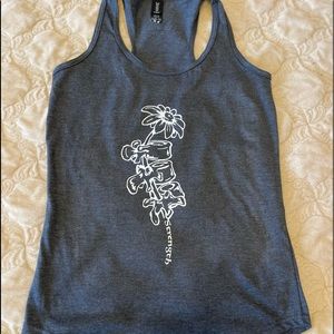 Flower/spine tank top with quote “strength”